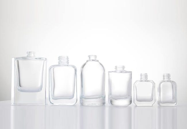 a group of empty clear perfume bottles